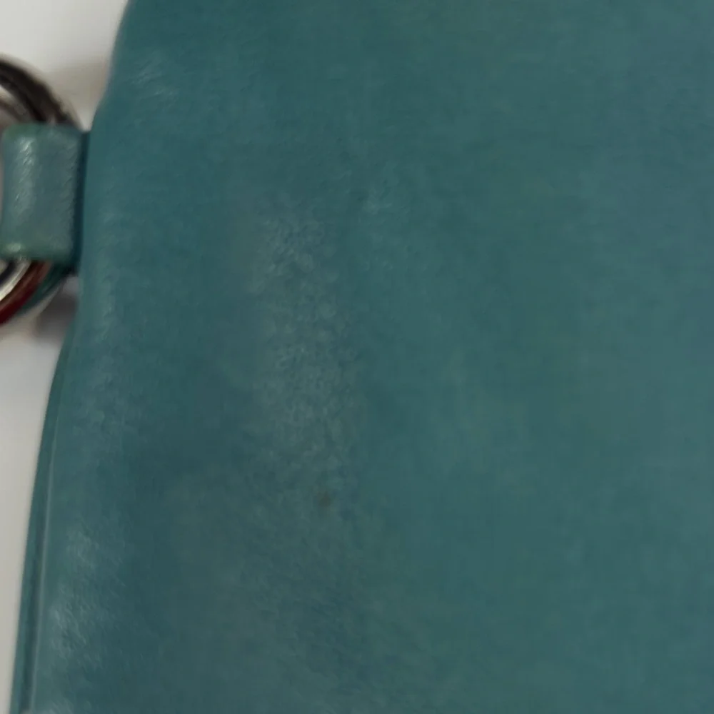 Coach turquoise leather wristlet w orig Coach hangtag, trigger snap closure